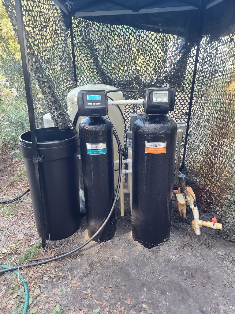 Water softener tanks under camouflage netting