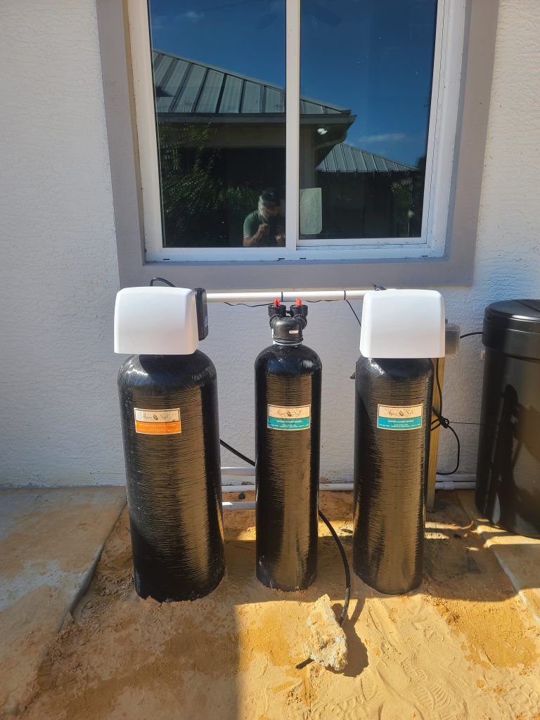 Three black water filter tanks under window